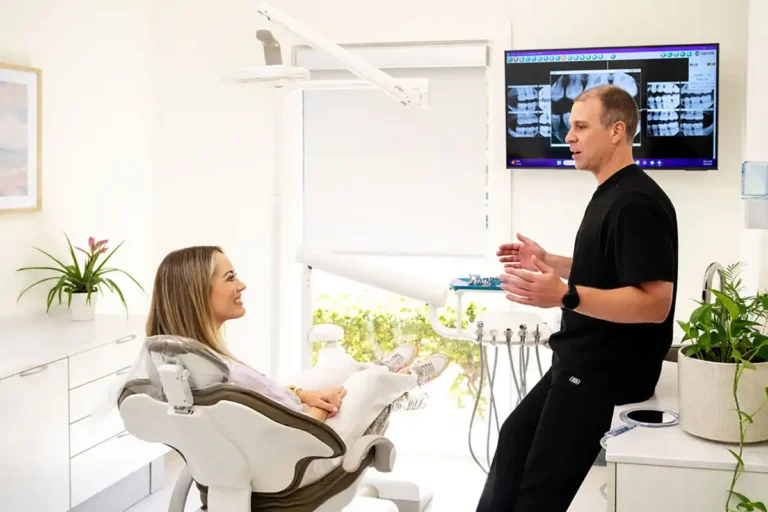 Dr. Grooters talking to a patient in a dental exam room at Apalachee Bay Family Dental in Tallahassee, FL.